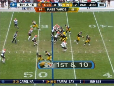 Roethlisberger delivers play action fake as Adams closes in and Mendenhall squares him up.